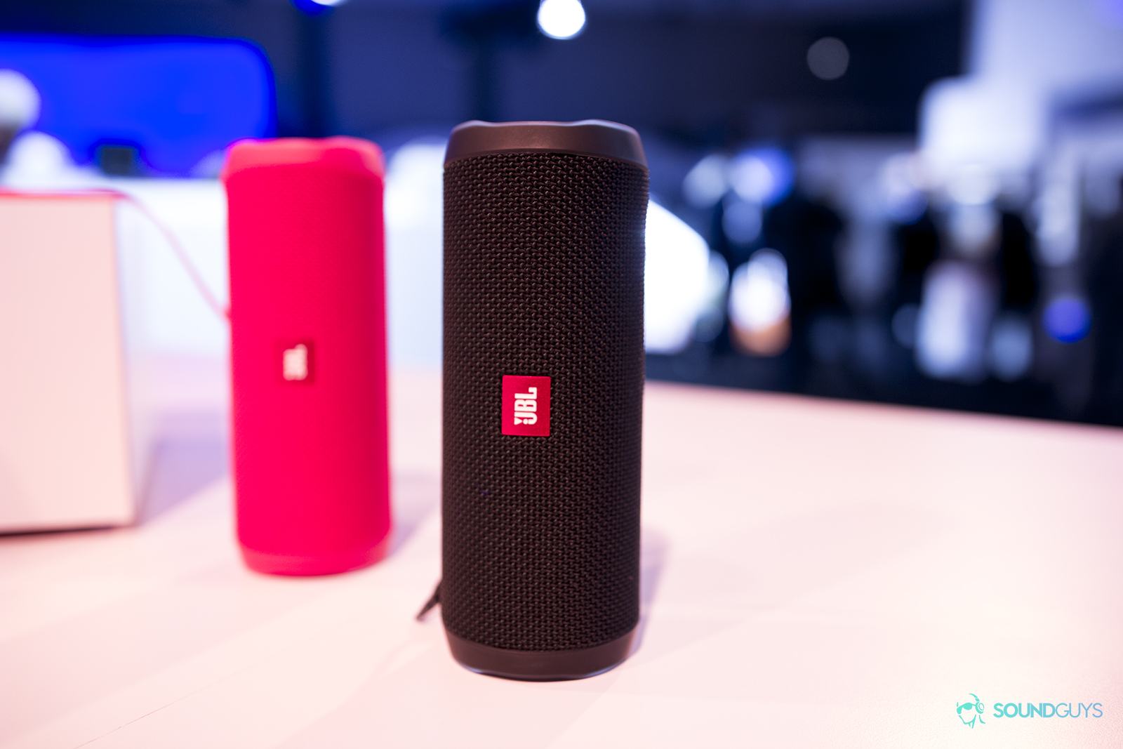 Two JBL speakers on a table top