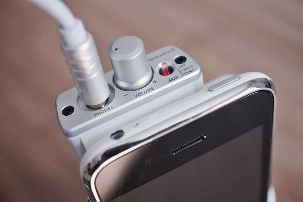 A photo of a headphone amplifier attached to a smartphone, shot by Flickr user mujitra.