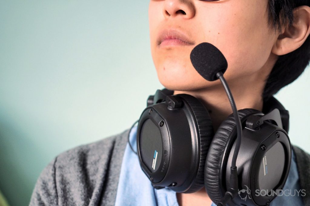 Beyerdynamic Custom Game headset being worn around the neck with the mic to the mouth.