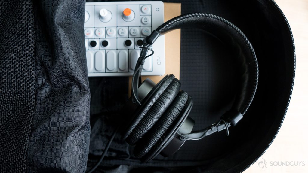 A photo of clean headphones, the Sony MDR-7506, fitting nicely into a backpack.