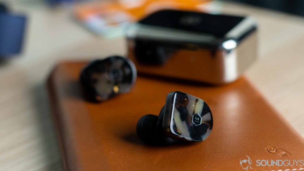 Close-up shot of the Master & Dynamic logo on the MW07 earbuds.