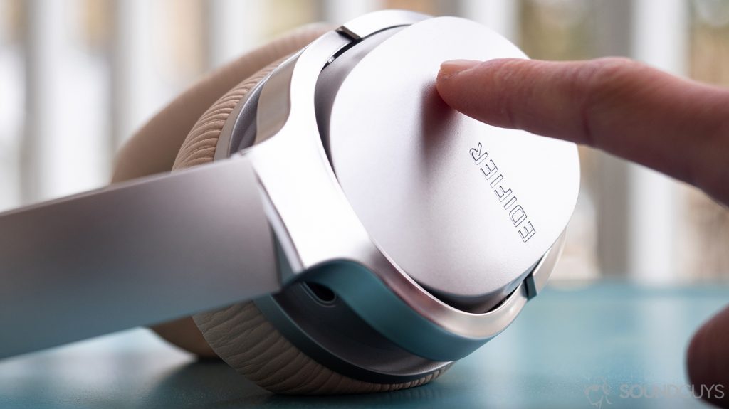 Edifier W860NB: A hand on the touch panel of these expensive headphones.