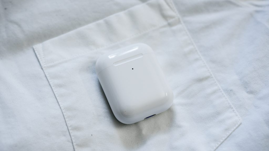 Shot of the Apple Airpods charging case on a white dress shirt. 