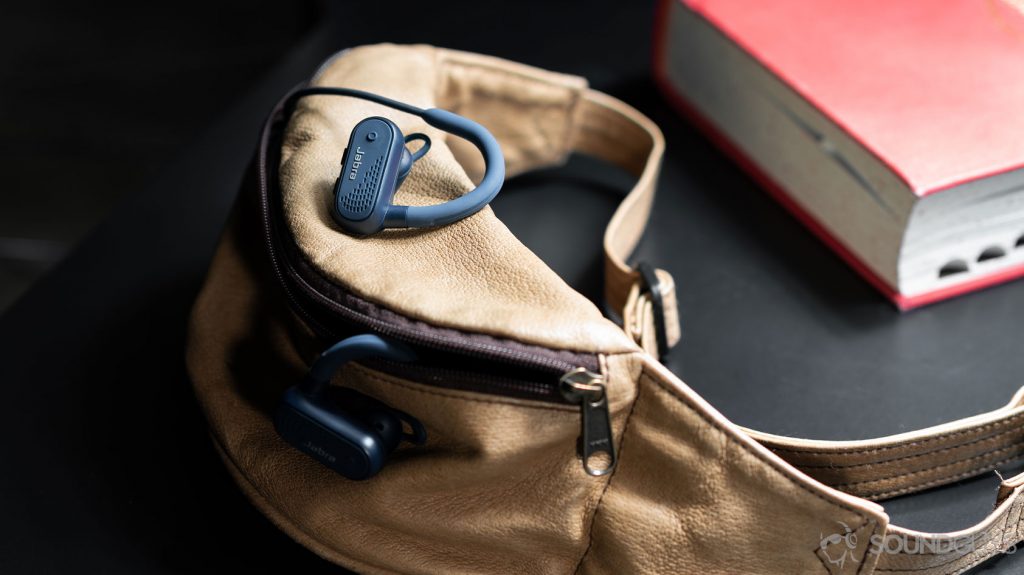 A photo of the Jabra Elite Active 45e earbuds coming out of a beige fanny pack.