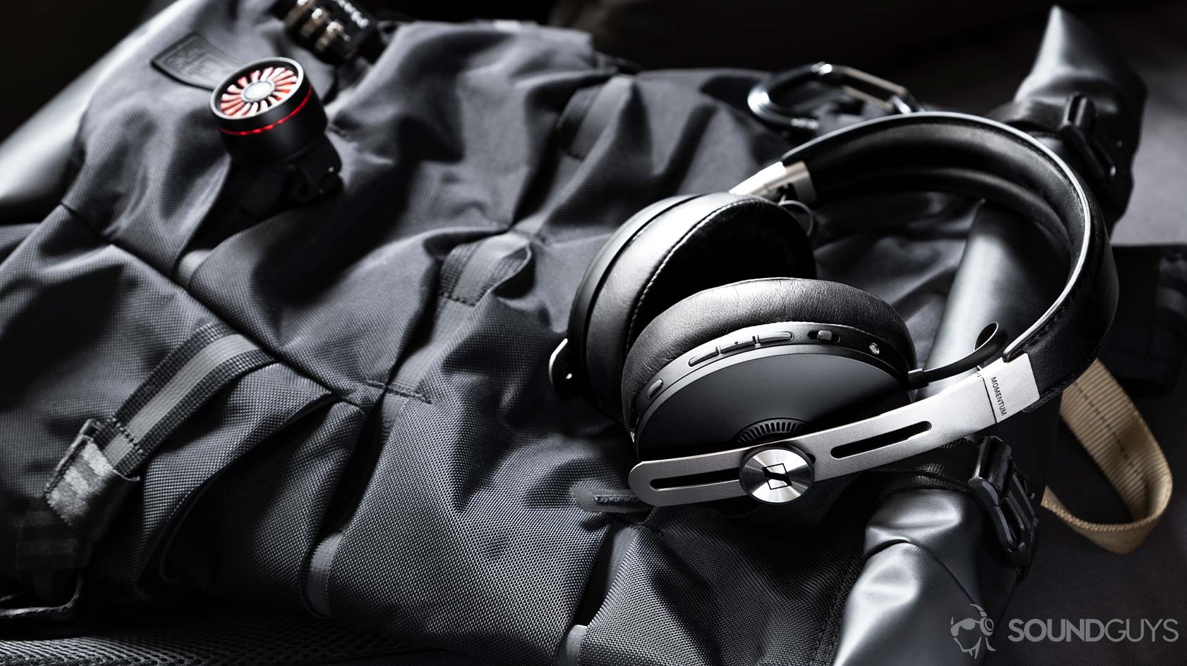 The Sennheiser Momentum Wireless 3 headphones lying flat on a backpack.