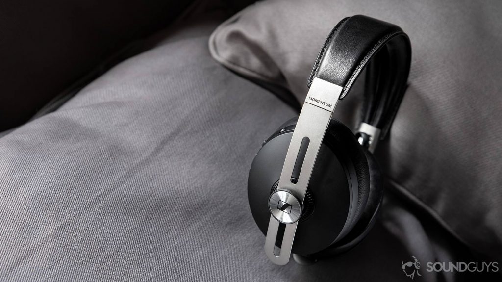 An angled photo of the Sennheiser Momentum Wireless 3 on a grey pillow.