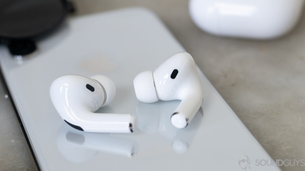 The Apple AirPods Pro noise cancelling true wireless earbuds rest on a smartphone.