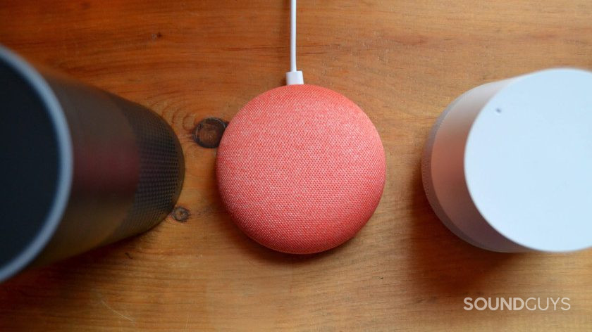 An aerial image of the best smart speakers including Amazon Echo, Google Home Mini, and Google Home on a wooden table.