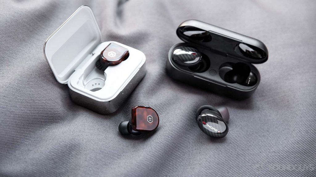 A picture of the 1More True Wireless ANC and Master & Dynamic MW07 noise canceling true wireless earphones and their respective charging cases; both headsets are pricier than the 1More Stylish True Wireless.