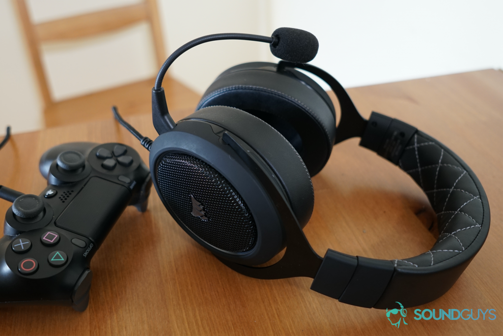 A Corsair HS60 Pro Surround sitting on a table plugged into a Playstation 4 controller