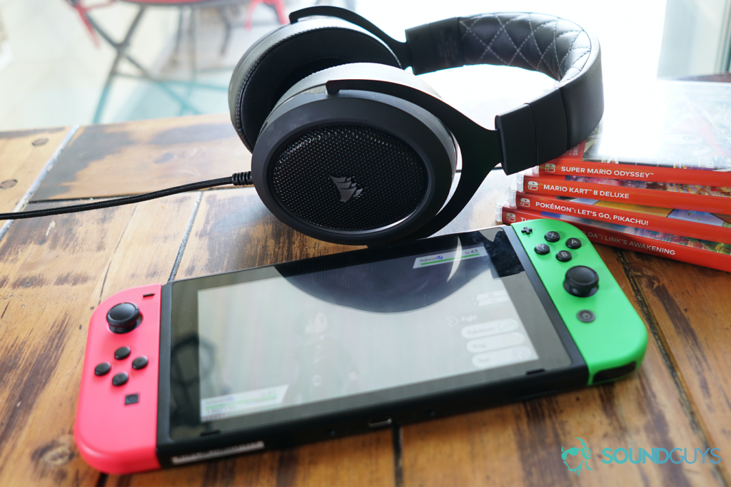 The Corsair HS60 Pro Surround leans on Mario Kart, Legend of Zelda, Mario Kart, and Pokemon games in front of a Nintendo Switch running Pokemon Sword.