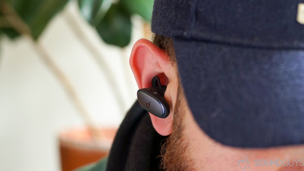 Man wearing the Anker Soundcore Liberty 2 Pro earbuds in the ear with blue hat.