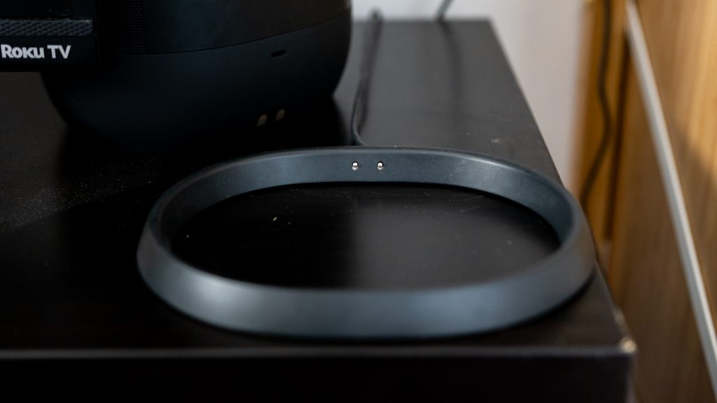 The charging cradle for the Sonos Move pictured on black surface