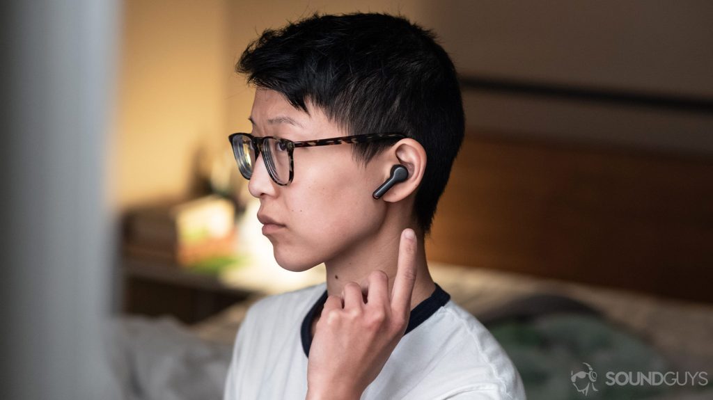 A photo of the Anker SoundCore Liberty Air 2 true wireless earbuds, a contender for the best workout earbuds, being worn and used by a woman in profile view.