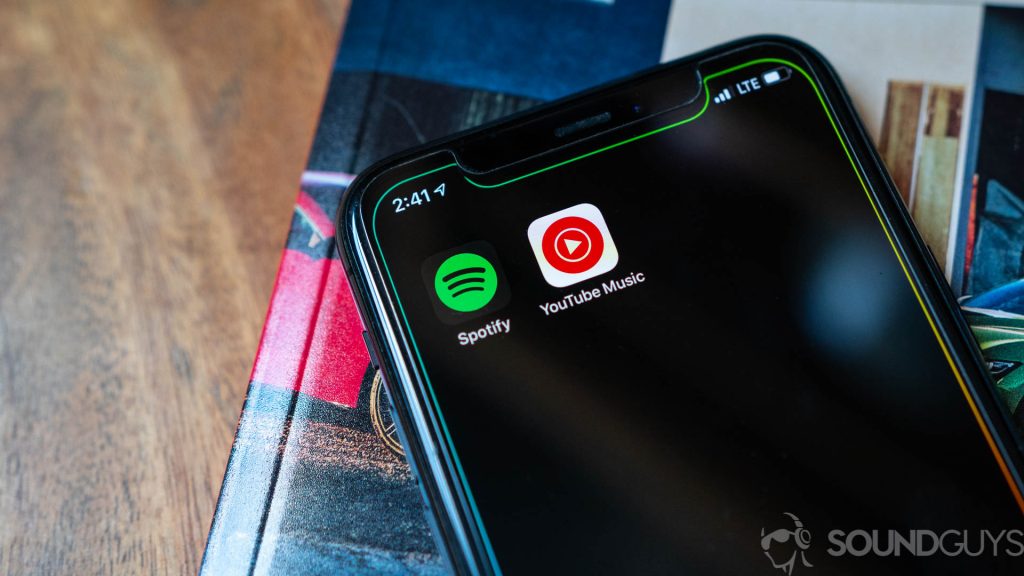 Close-up shot of the YouTube Music and Spotify appi icons on iPhone