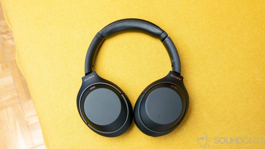 Sony WH-1000XM4 headphones on a yellow couch