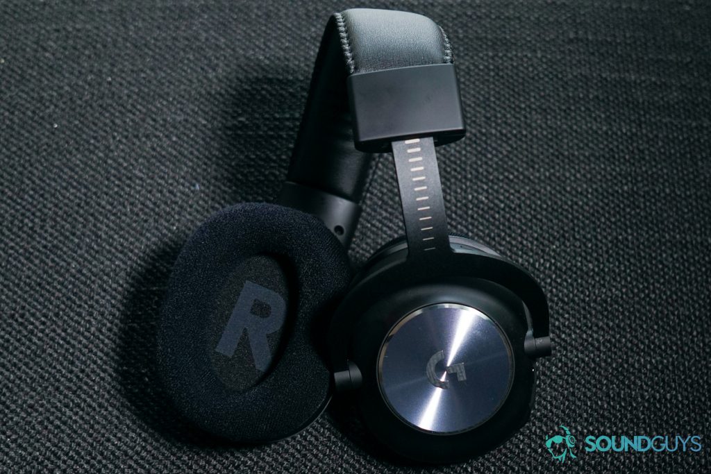The Logitech G Pro X Wireless gaming headset sits on a fabric surface with its additional velour ear pads attached.