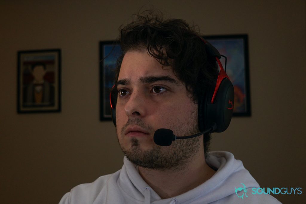 A man wears the HyperX Cloud II Wireless gaming headset sitting at a PC