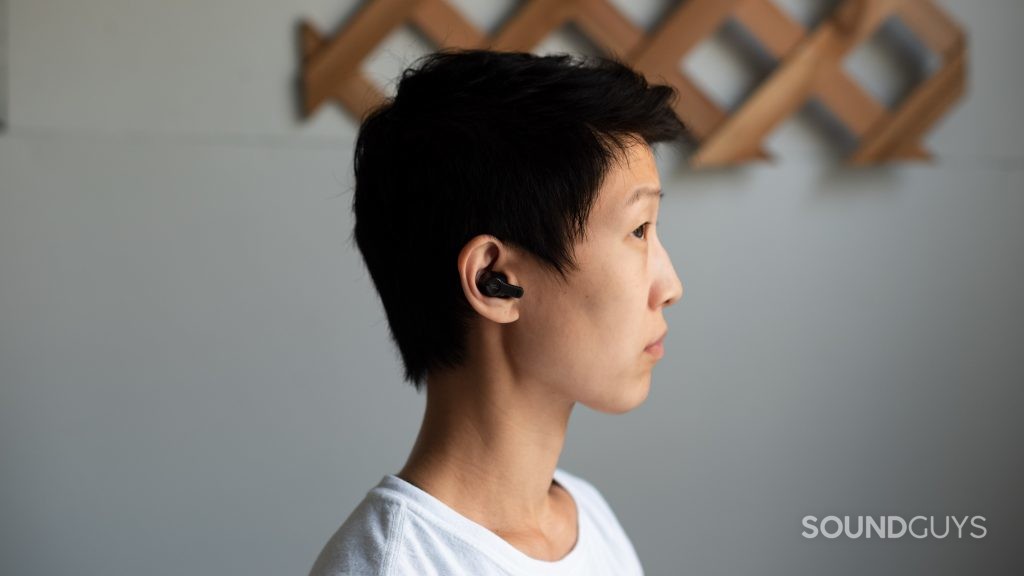 A woman wears the 1MORE PistonBuds cheap true wireless earbuds.