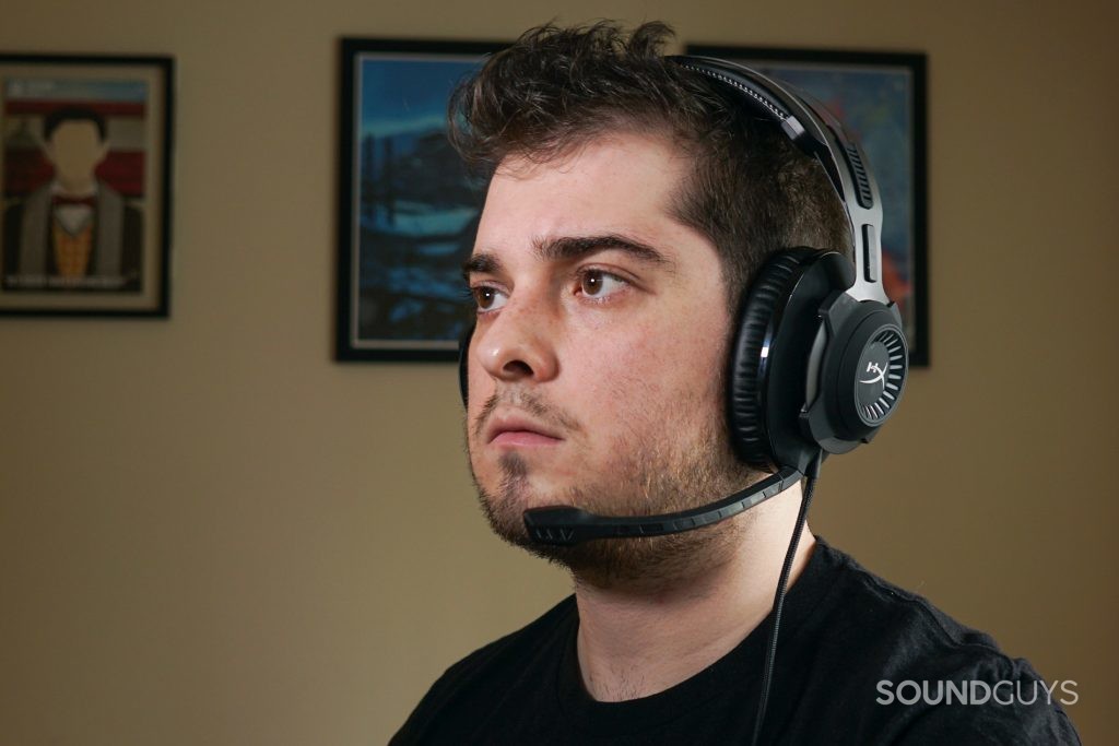 A man wears the HyperX Cloud Revolver + 7.1 gaming headset sitting at a PC