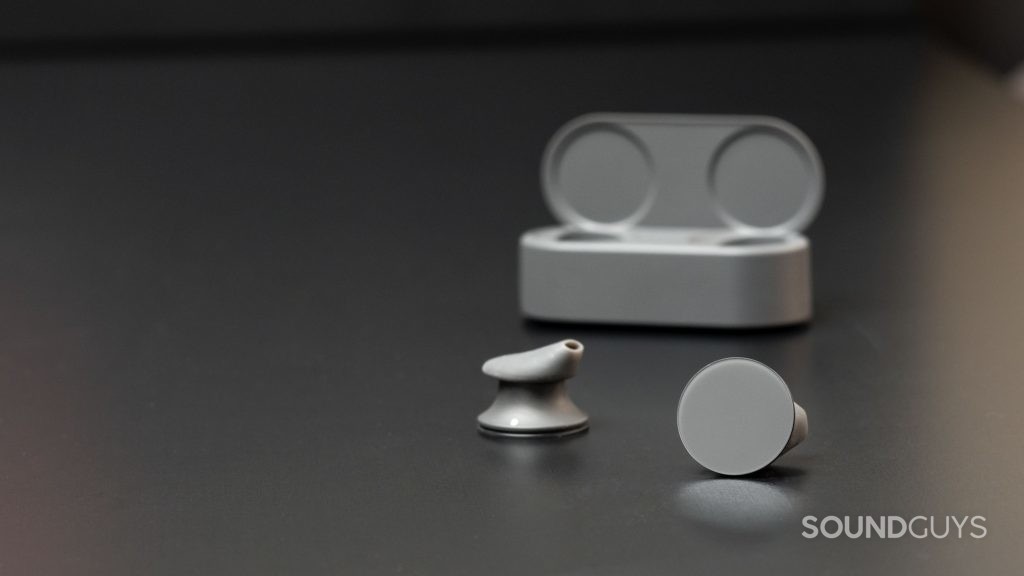The Microsoft Surface Earbuds outside of the open charging case.