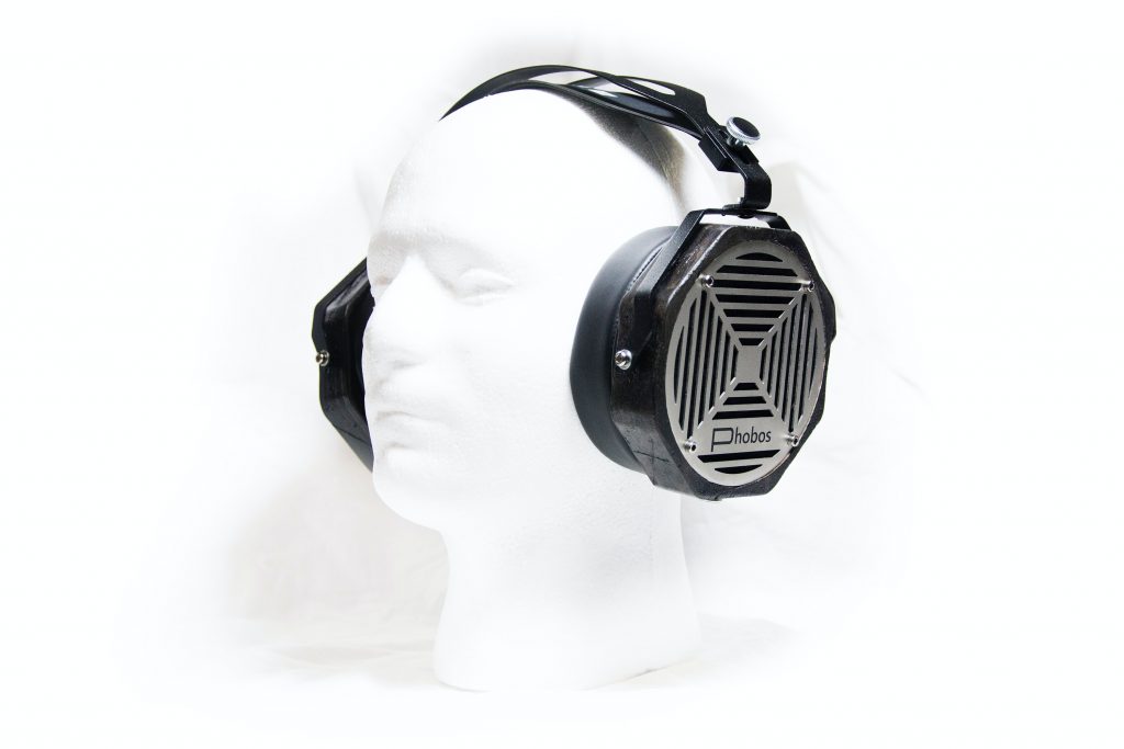 Dummy head wearing open back headphones