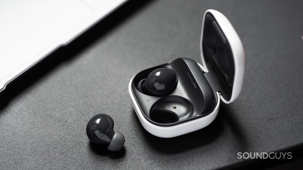 The Samsung Galaxy Buds 2 noise cancelling true wireless earbuds with one 'bud out of the open, angled charging case.