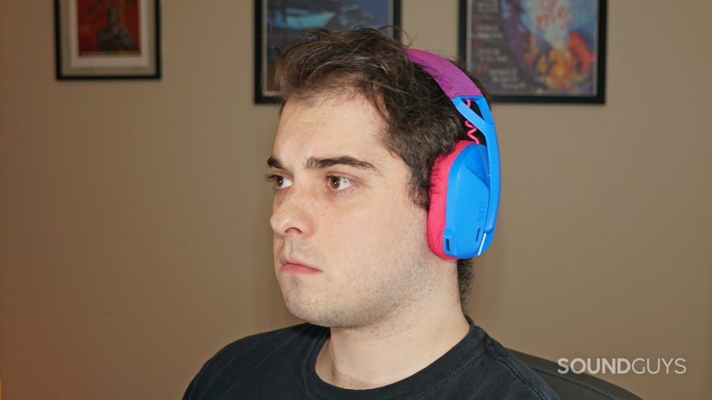 A man wears the Logitech G435 gaming headset sitting at a computer.