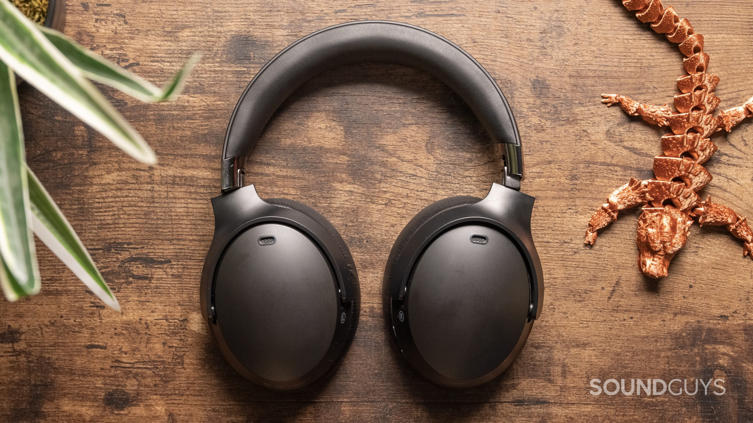 The Monoprice Dual Driver Bluetooth Headphones on table flat