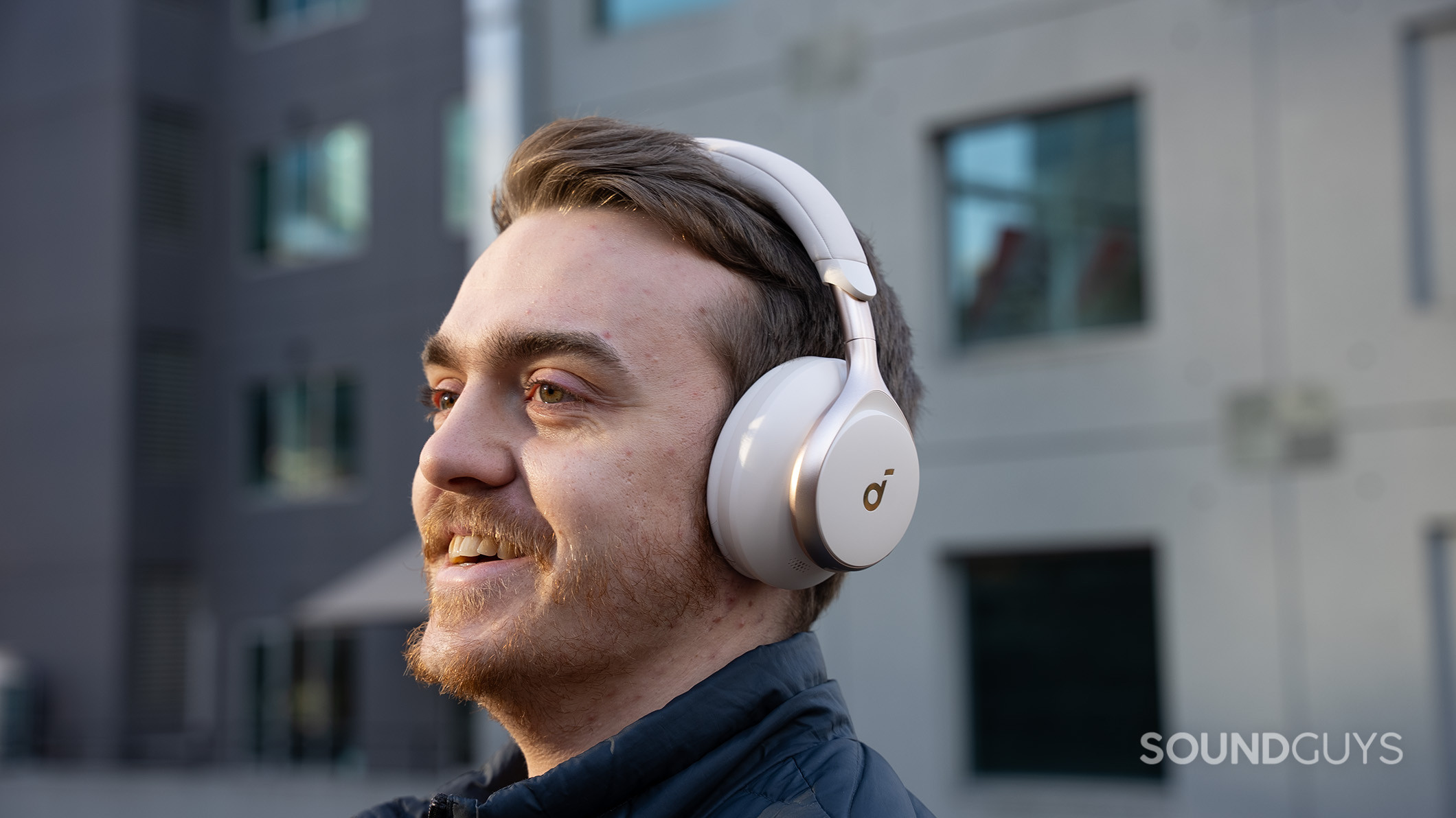 A man smiles while wearing the Anker Soundcore Space One.