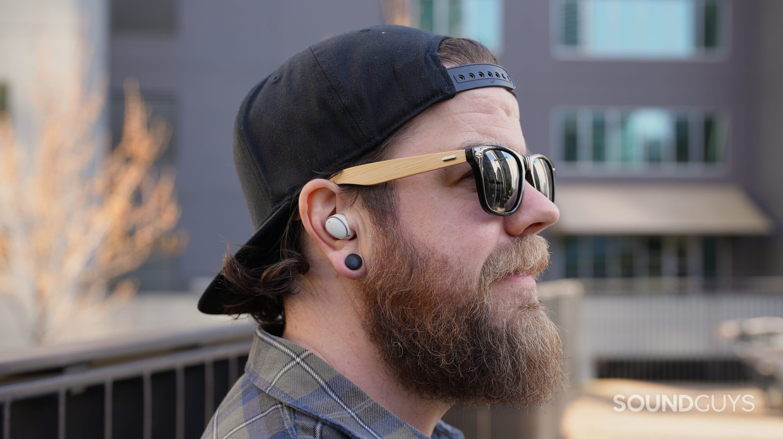 Side shot photo of a man wearing the 1MORE EVO earbuds.