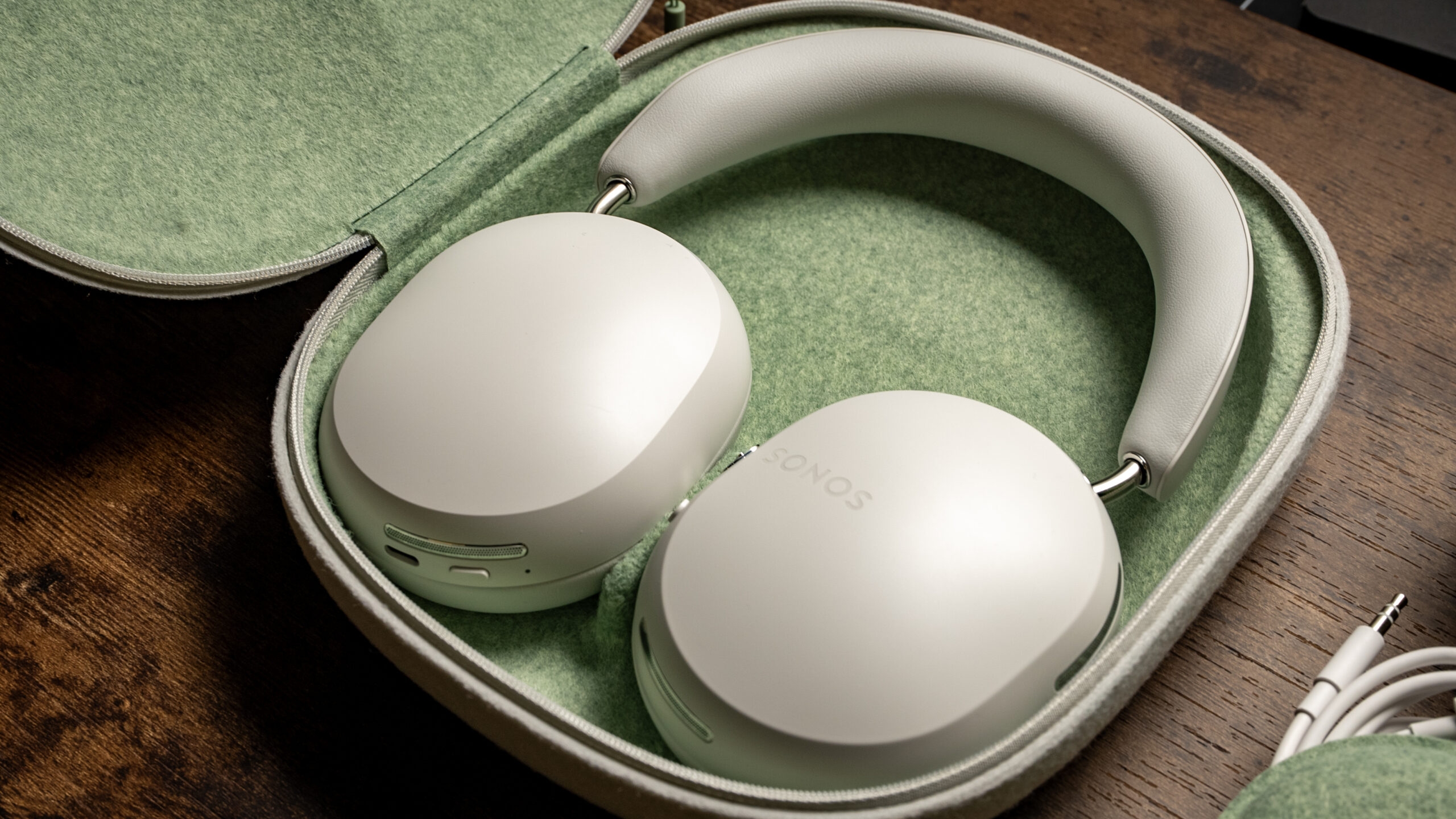 A picture of the Sonos Ace headphones placed inside of its mint green-interior carrying case