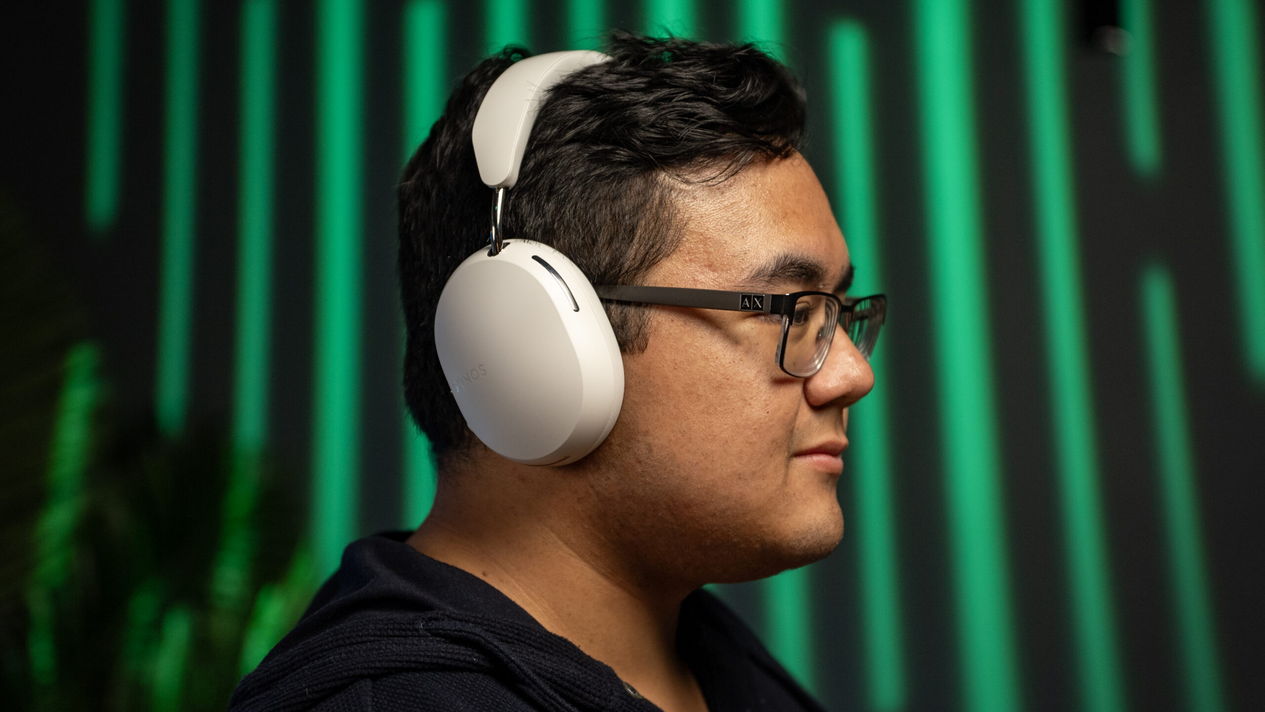 A side profile photo of a man wearing the Sonos Ace headphones