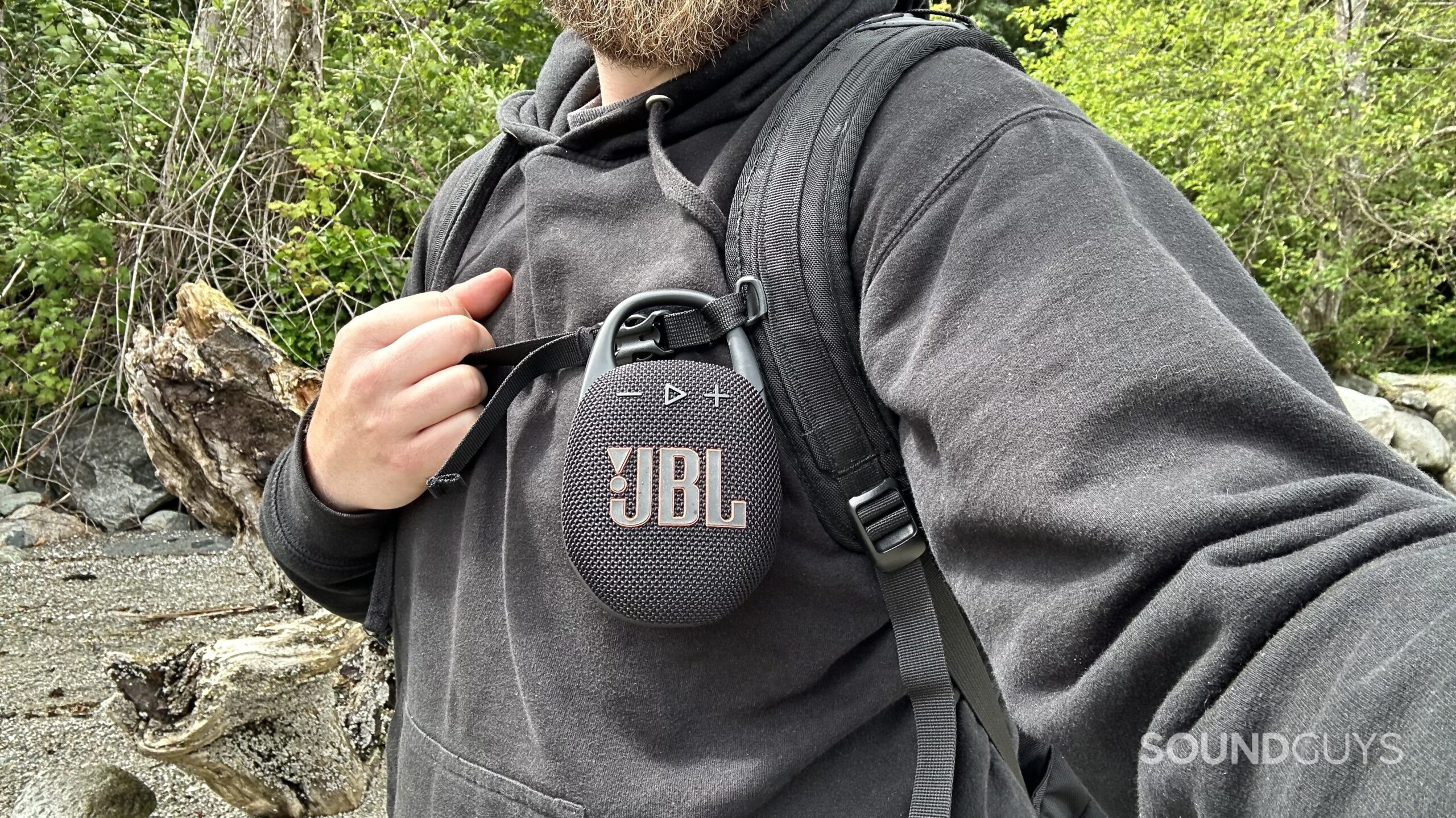 A JBL Clip 5 attached to a backpack.