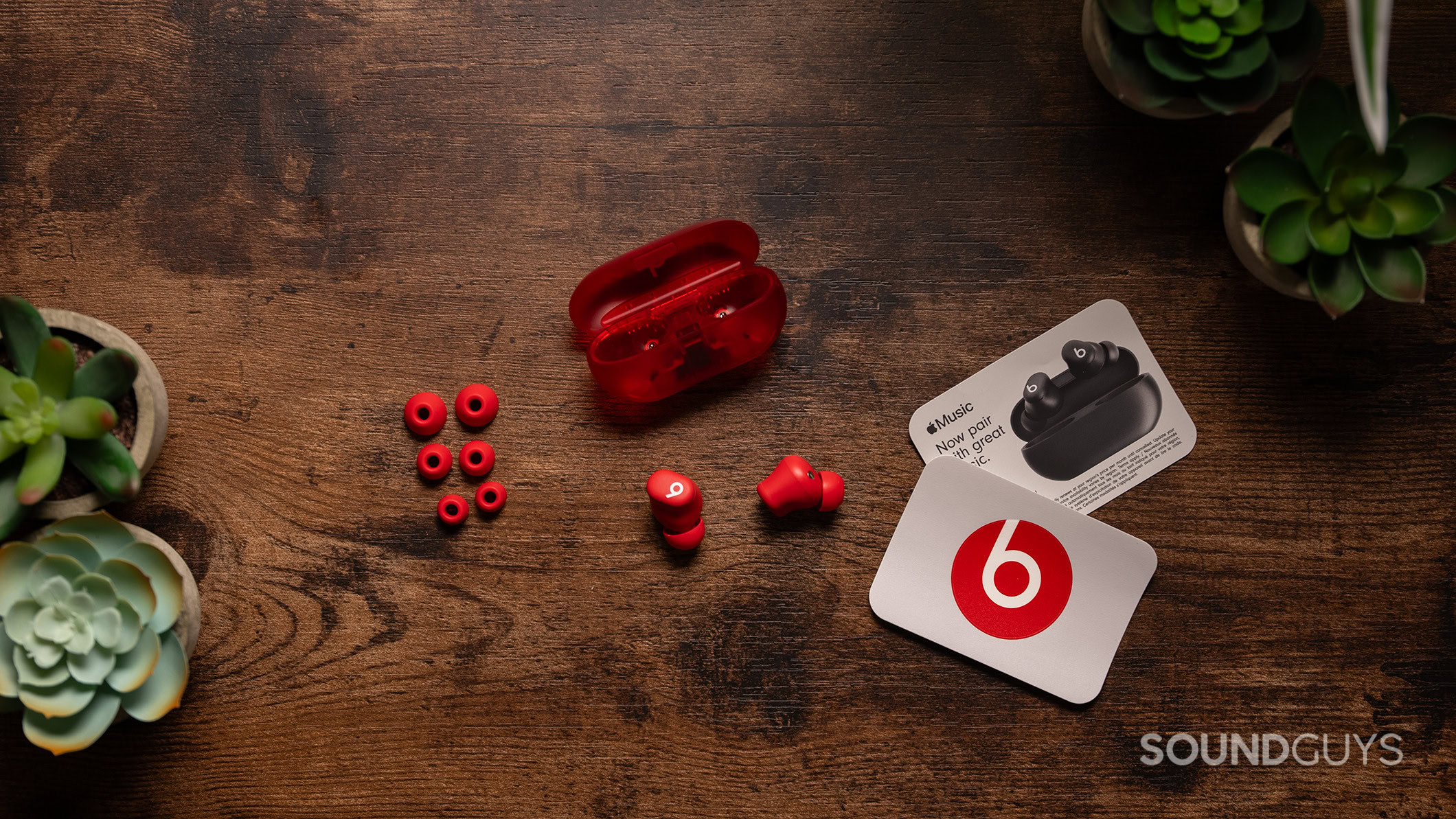 The Beats Solo Buds on a table with extra ear tips and packaging materials.