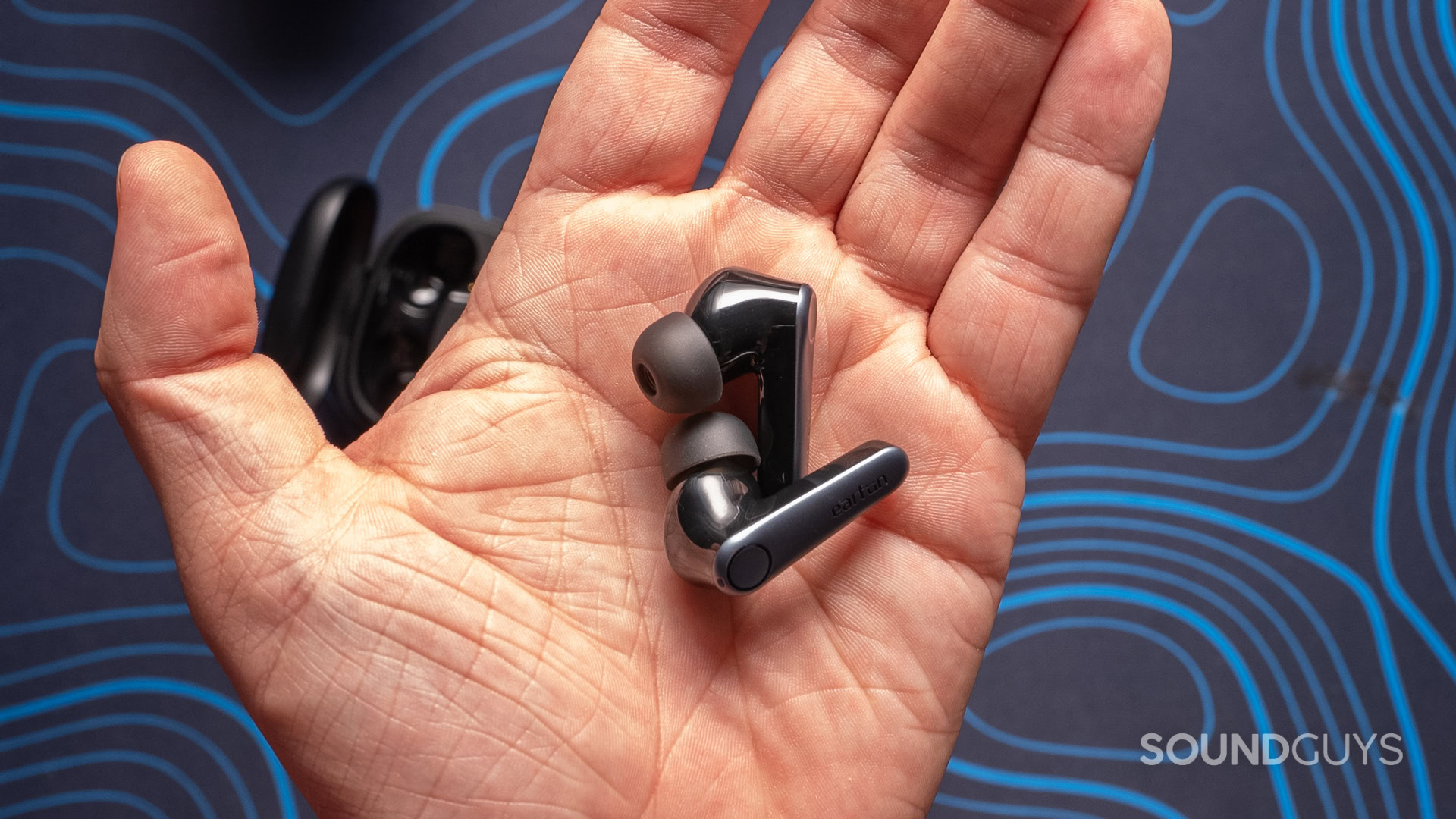 A photo of the EarFun Air Pro 3 earbuds in someone's hand.
