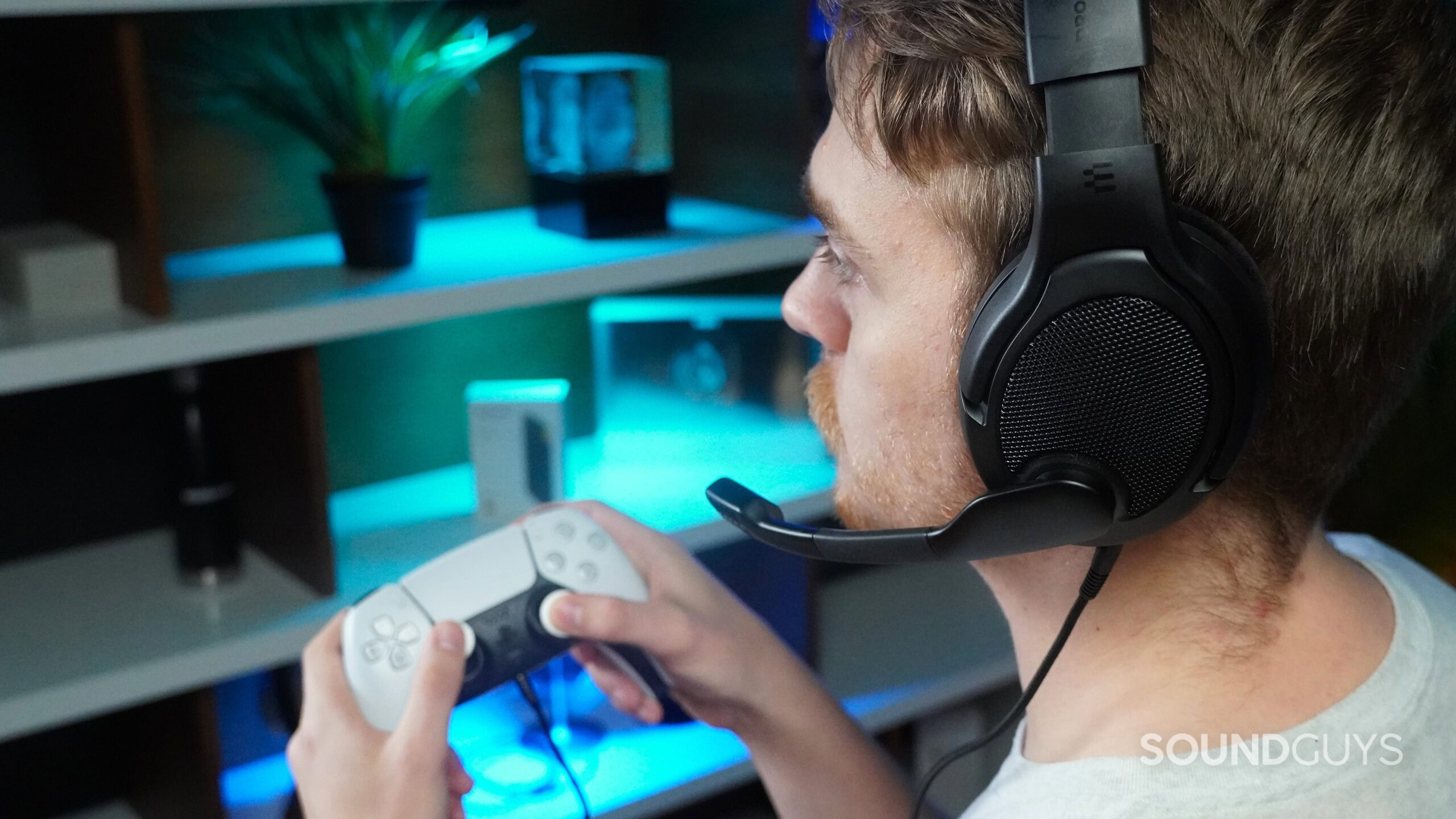 a man wearing a gaming headset while using a PS5 controller