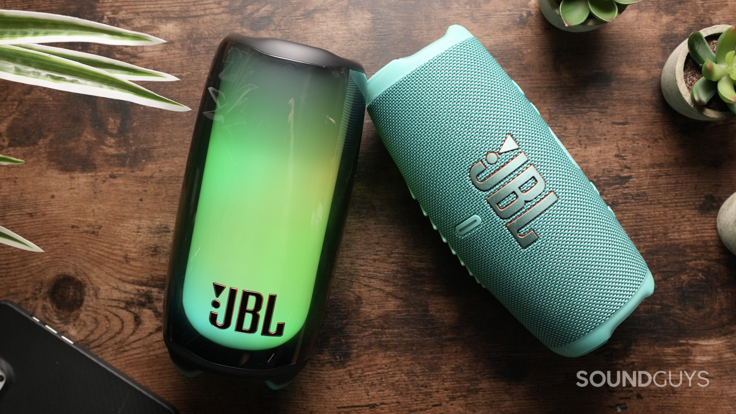 Top down shot of a JBL Pulse 5 beside a JBL Charge 5.