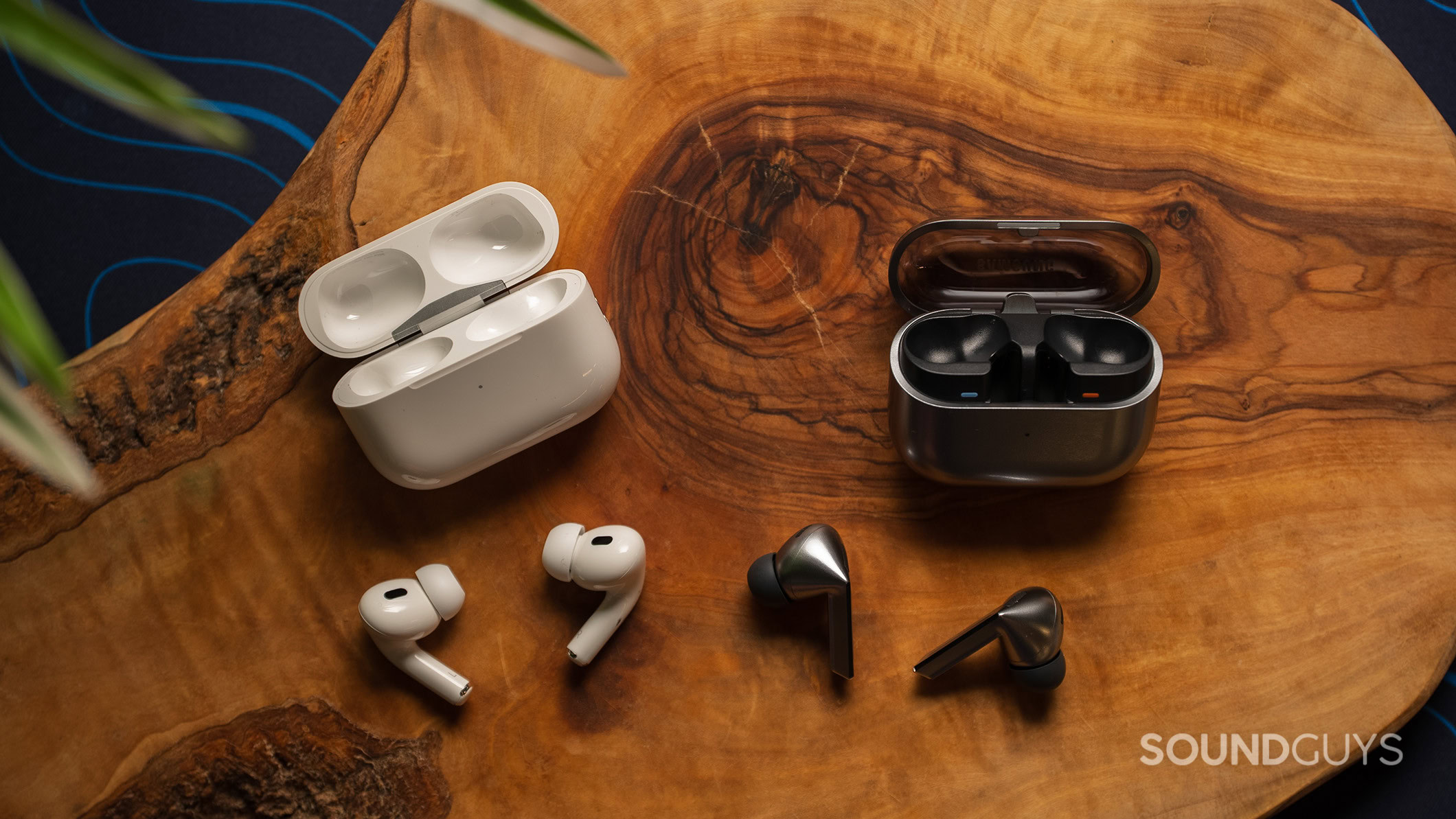 The Samsung Galaxy Buds3 Pro on a table next to the Apple AirPods Pro 2.