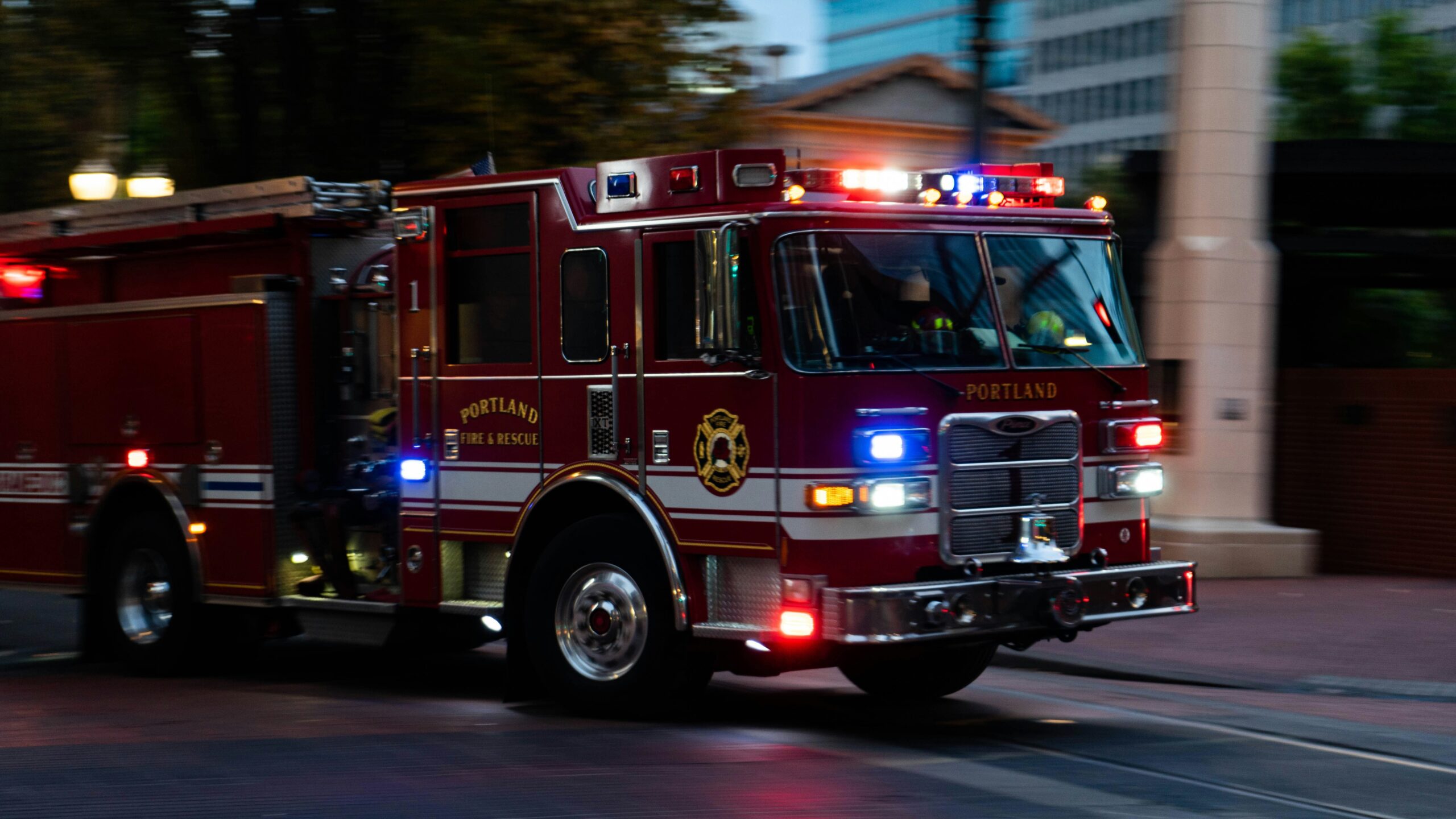 a firetruck racing down the street with sirens on