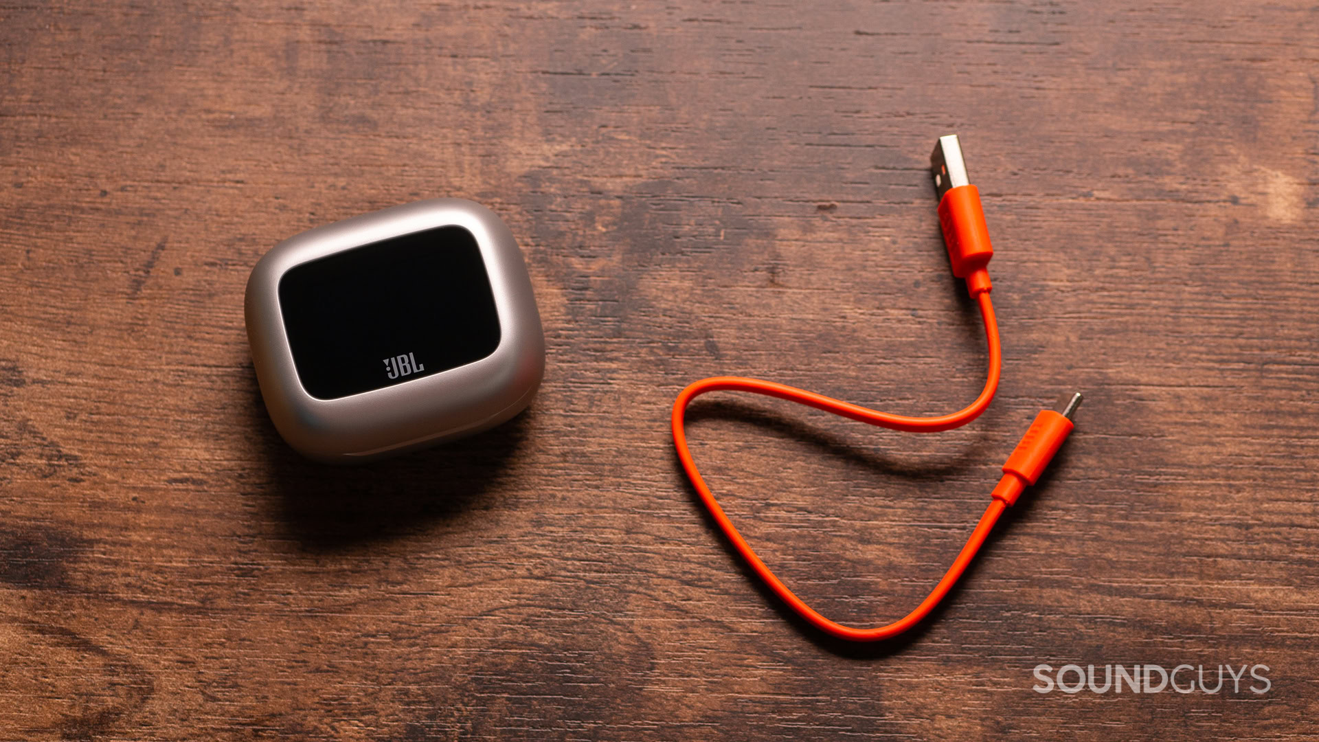 A photo of the JBL Live Beam 3 and its charging cable.