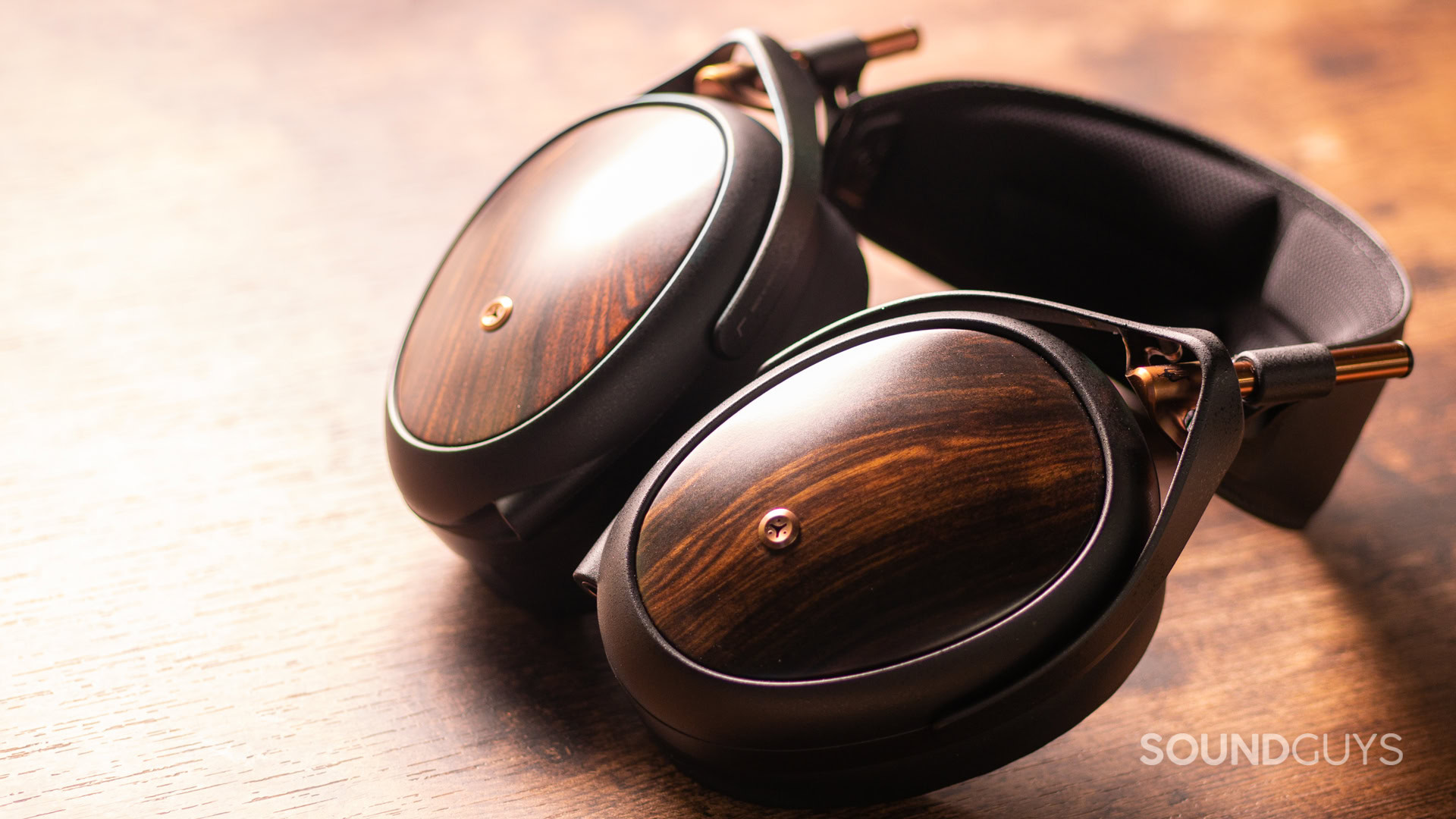 The Meze Audio Liric II sits atop a wooden desk.