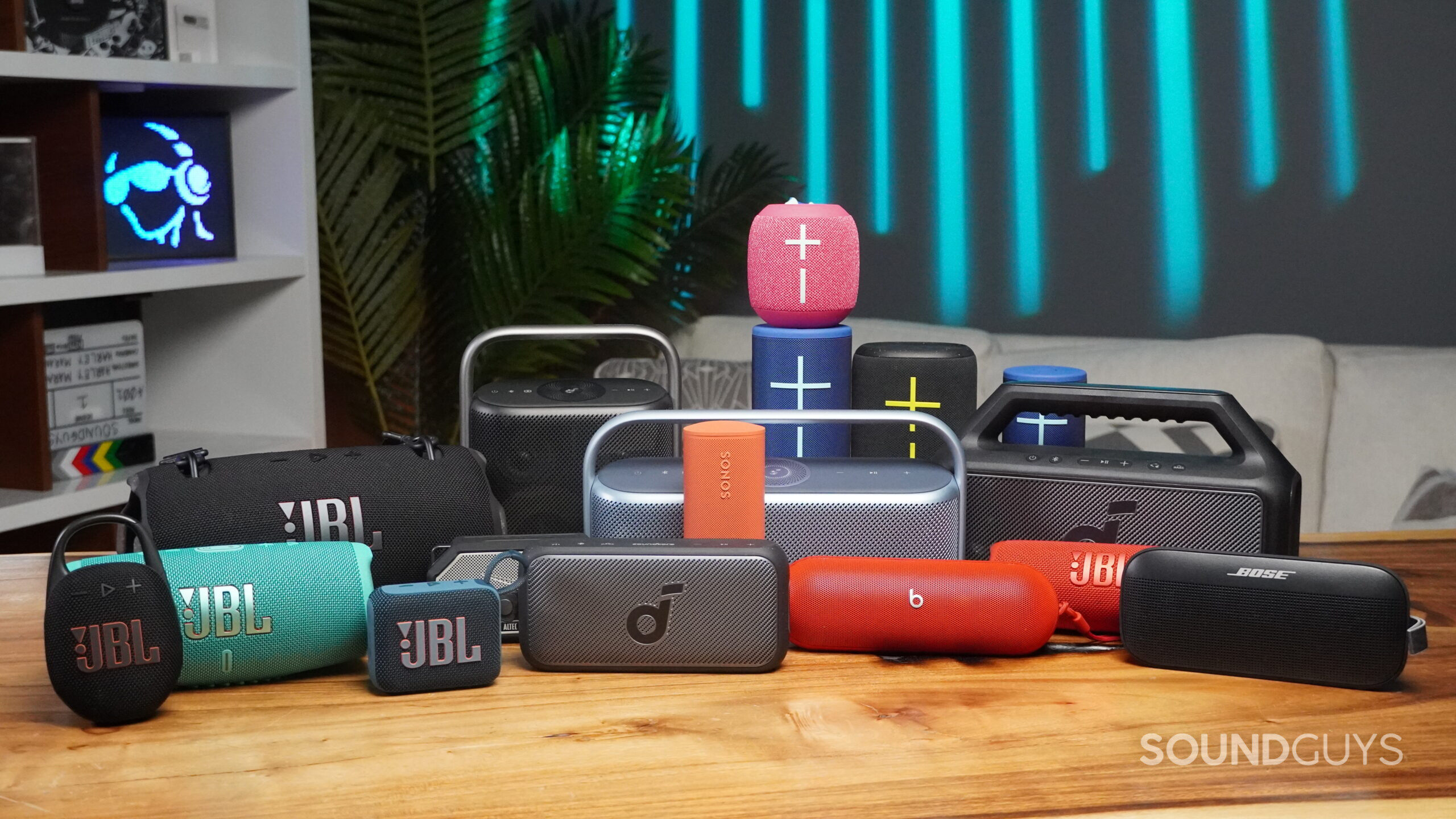 a bunch of portable bluetooth speakers on a table