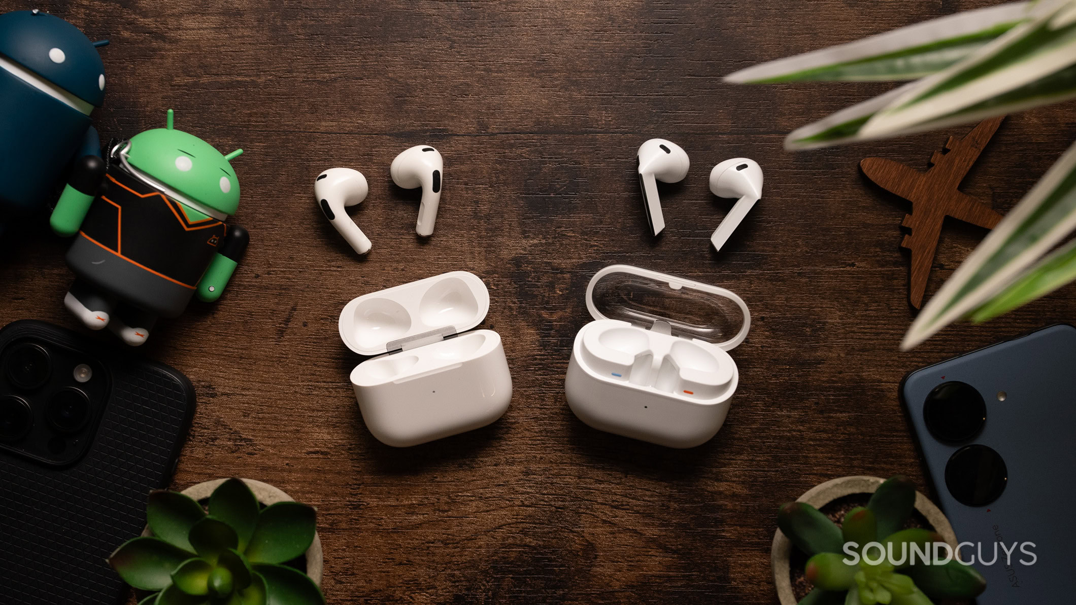 Samsung Galaxy Buds3 on a table next to Apple AirPods (3rd generation). 