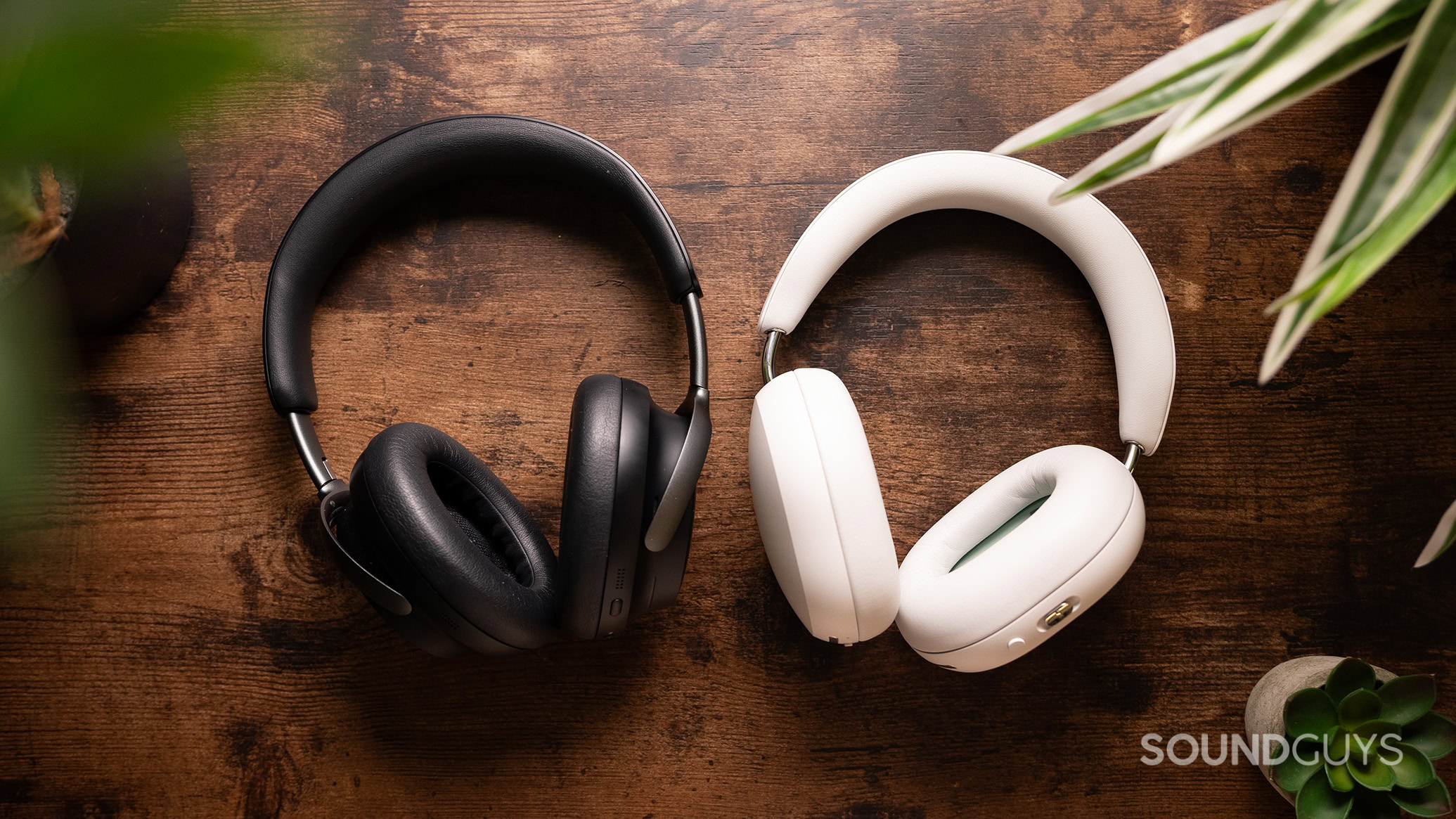 Sonos Ace next to Bose QuietComfort Ultra Headphones on a wood table.