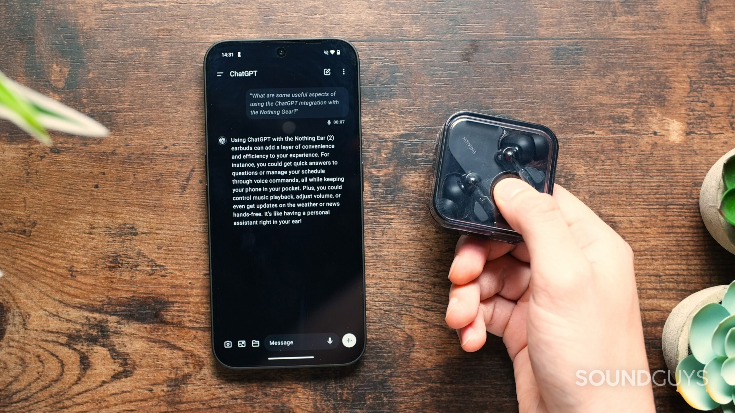 a hand holding the Nothing Ear case beside a phone with ChatGPT on screen