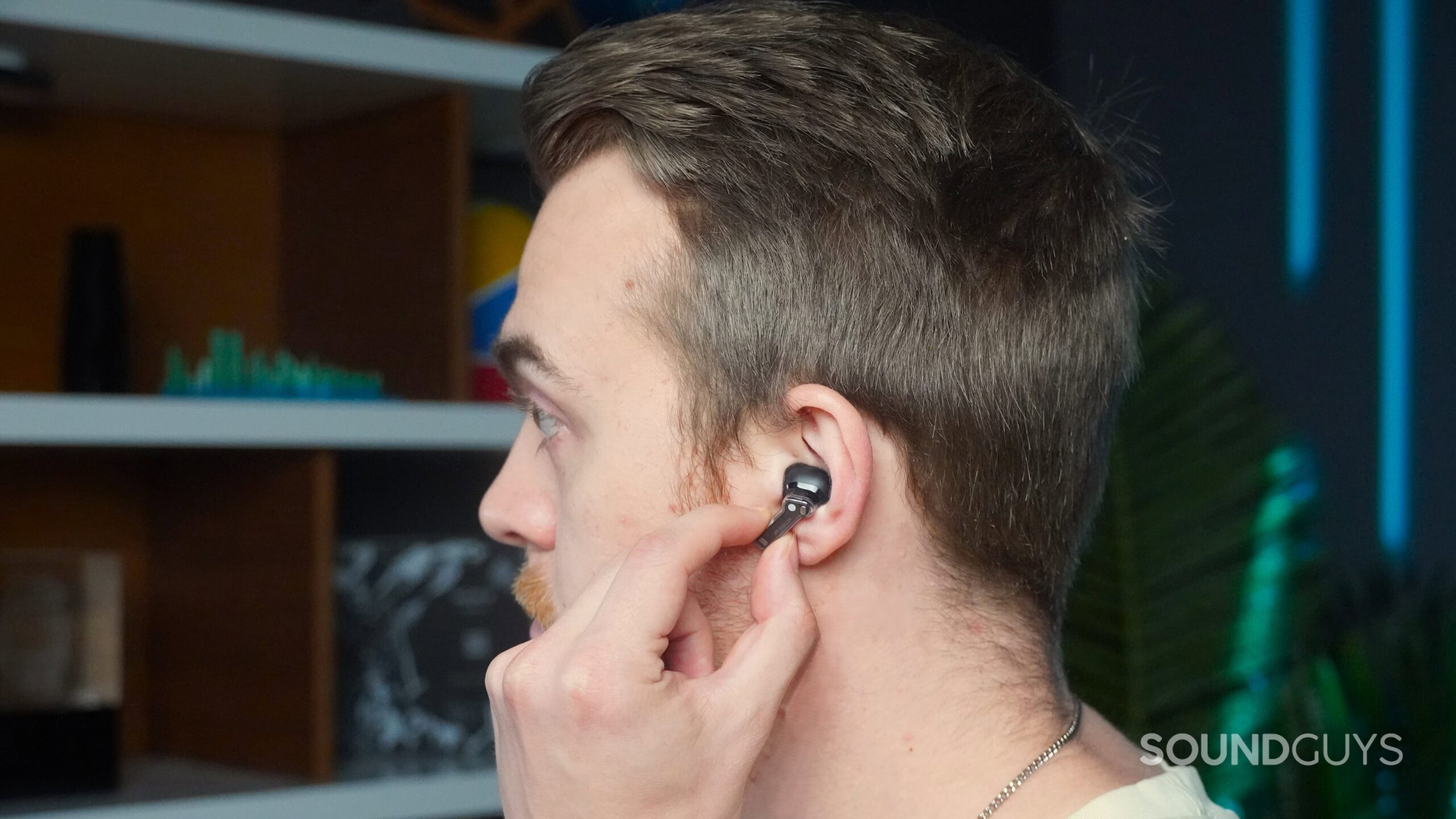 a man using pinch controls on the Nothing Ear