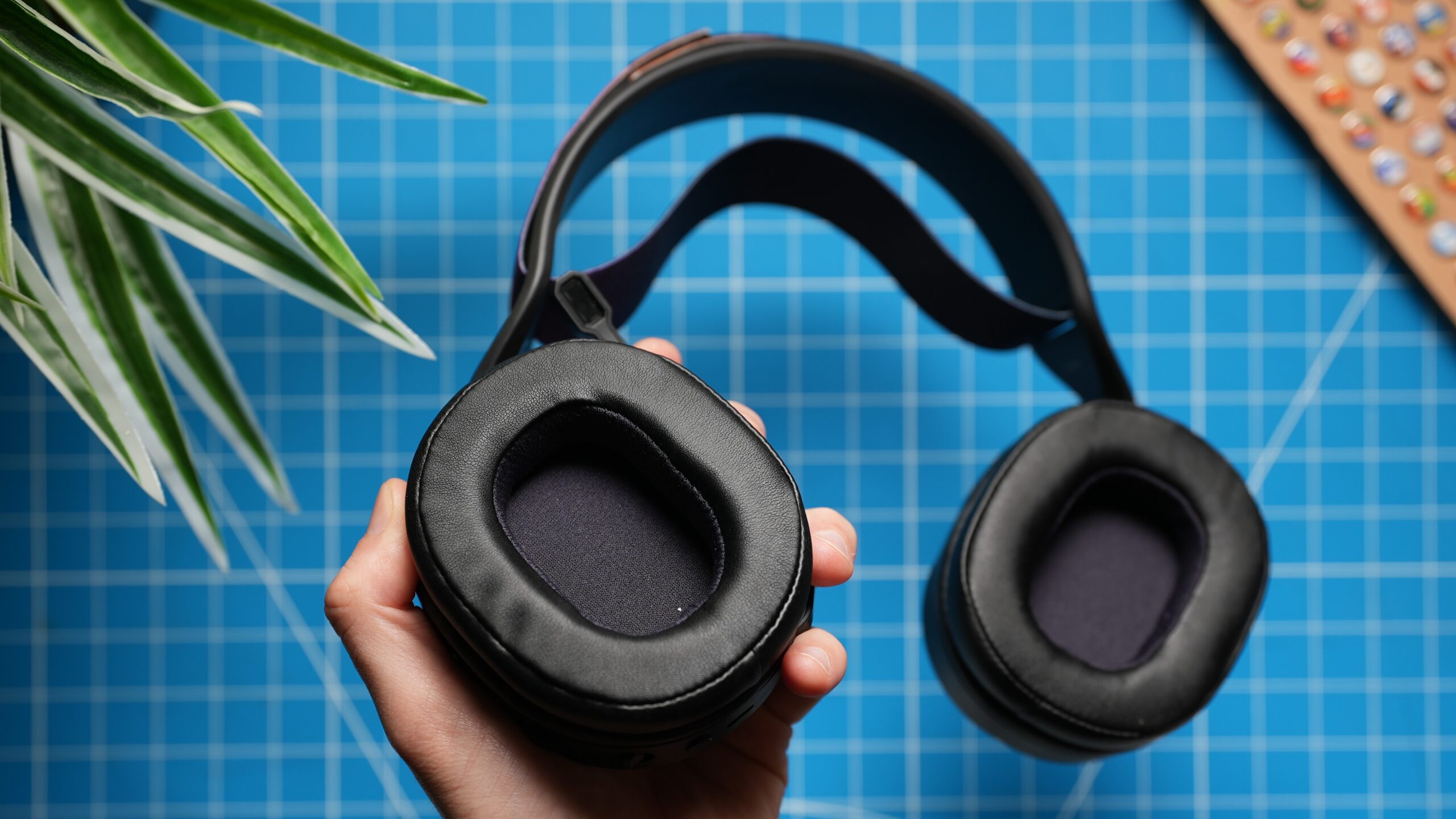 a hand showing the inside of the jlab nightfall wireless earcups