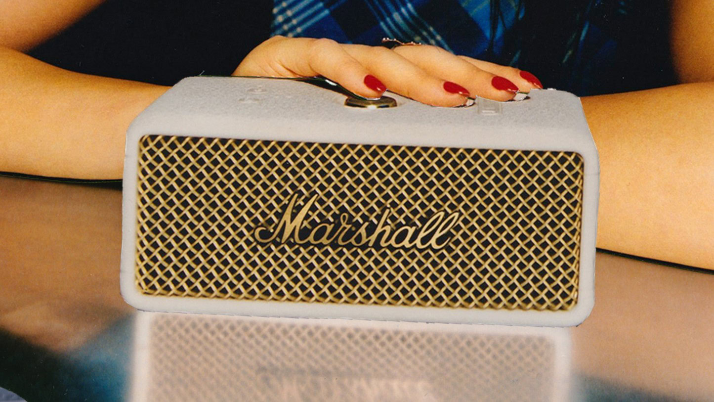 a hand resting on the marshall emberton III speaker