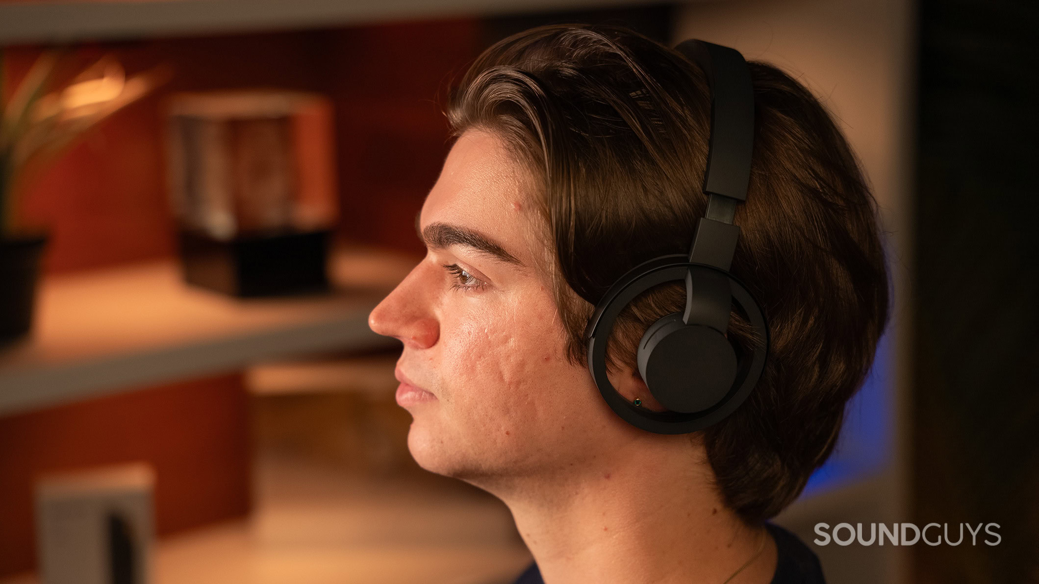 A man wearing the nwm ONE headphones. 